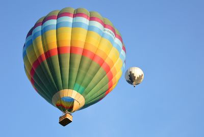 zwei Heißluftballone fliegen im blauen Himmel in wohl ferne Gestaden.